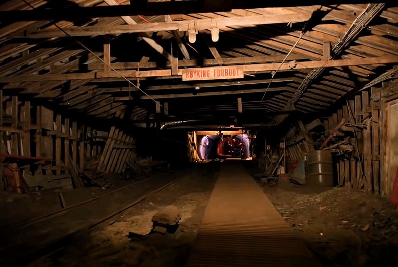 A dark coal mine tunnel leading to the GitHub code vault in Svalbard.