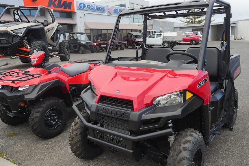 side by side bike next to a quad bike without a roll bar