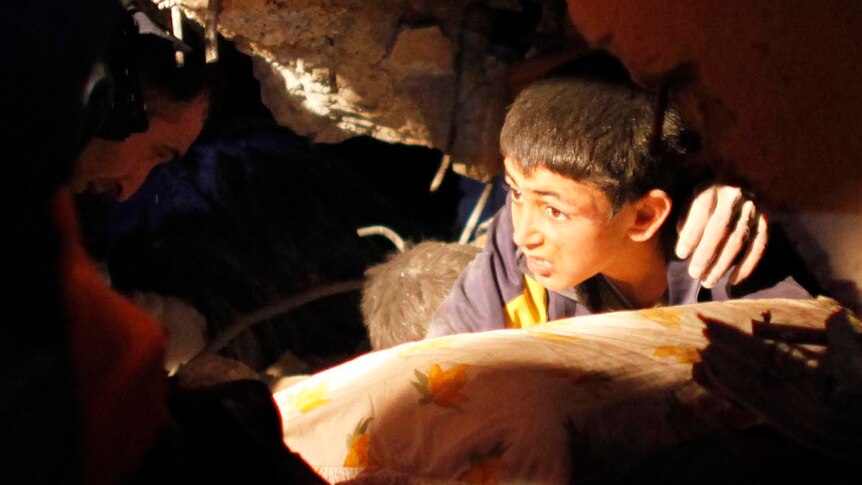 Watch footage of a young boy being rescued from the rubble of a collapsed building near Van