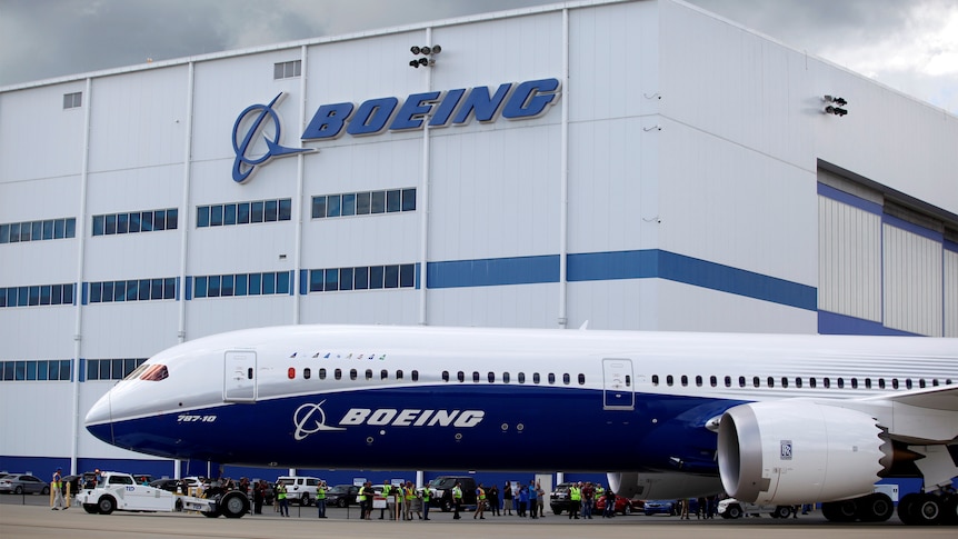 A Boeing plane taxis past the Boeing manufacturing centre.