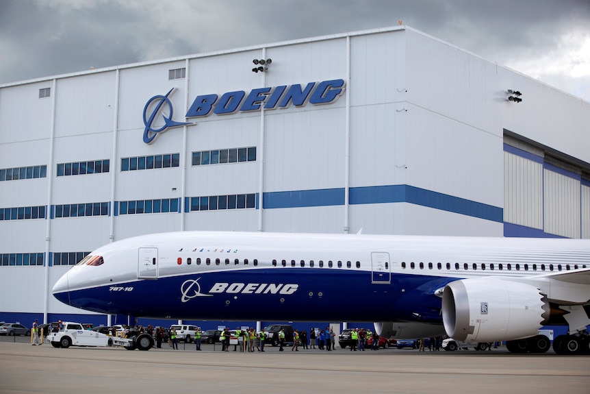A Boeing plane taxis past the Boeing manufacturing centre.