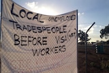Workers blockade site over use of foreign labor