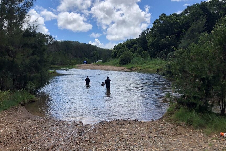 Police divers search the river where a man went missing.