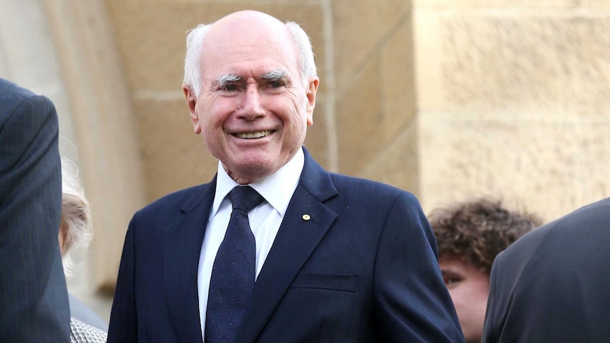 John Howard stands outside St Mary's Cathedral, Hobart, after the state funeral of Brian Harradine.