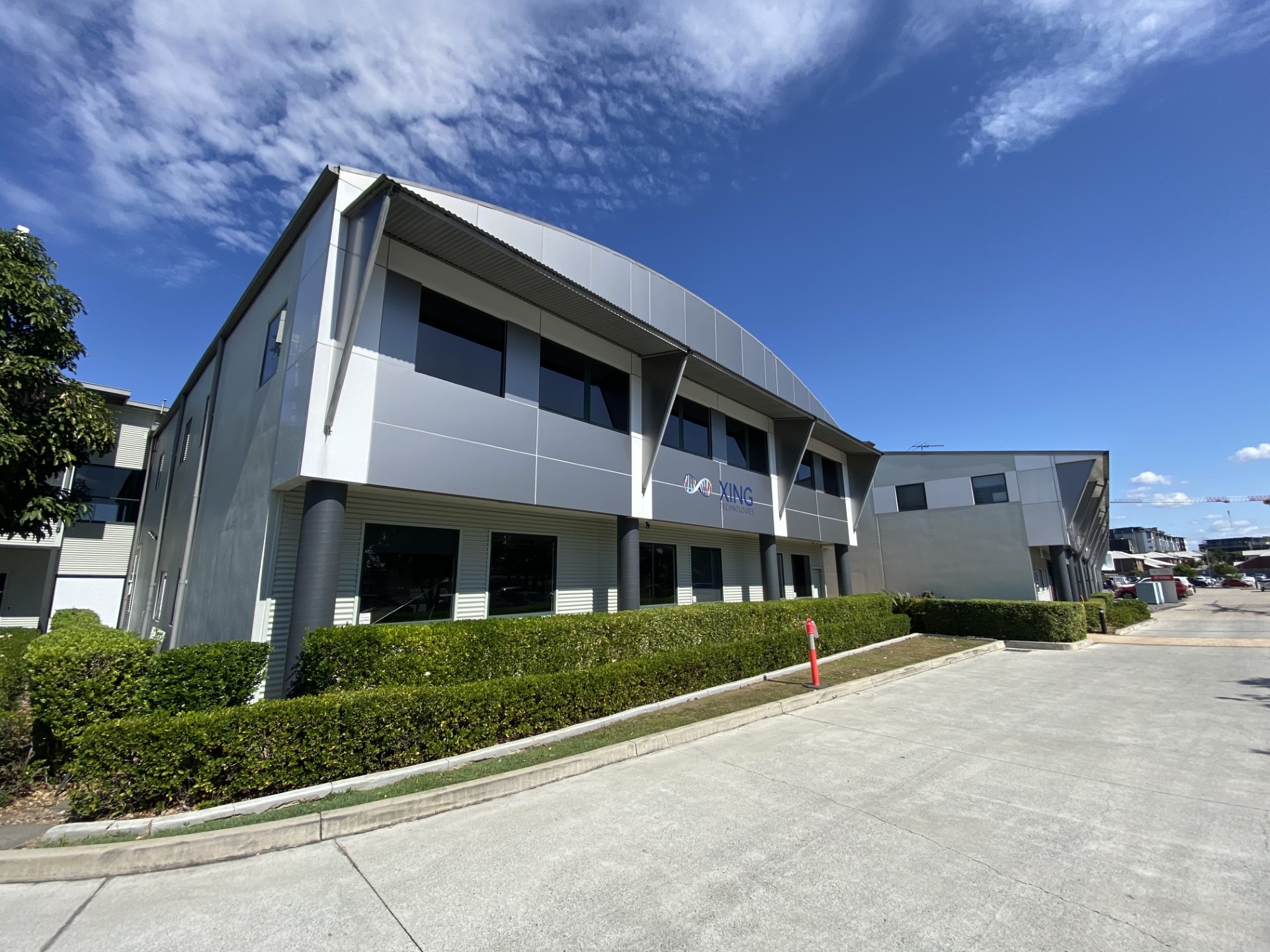 The outside of a grey office building.