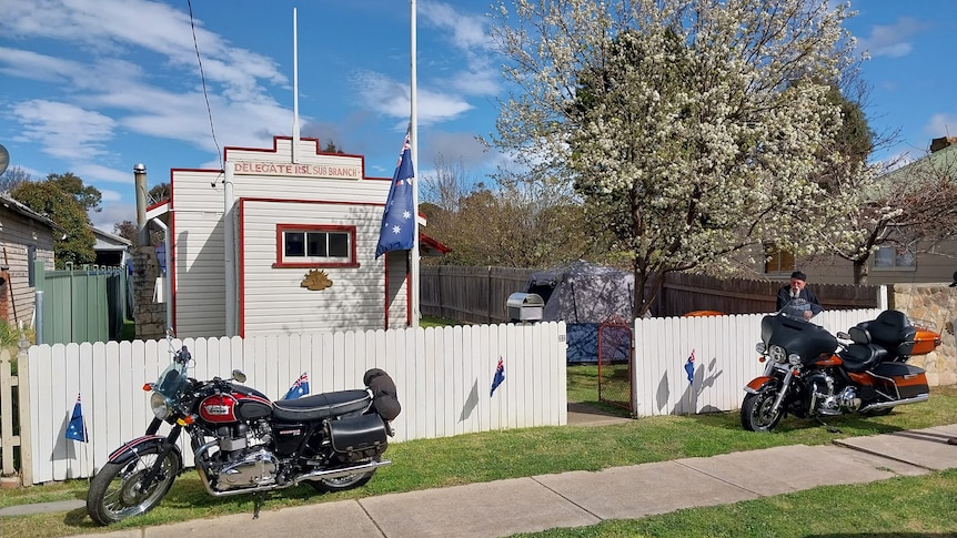 a small building with motorbikes at the front