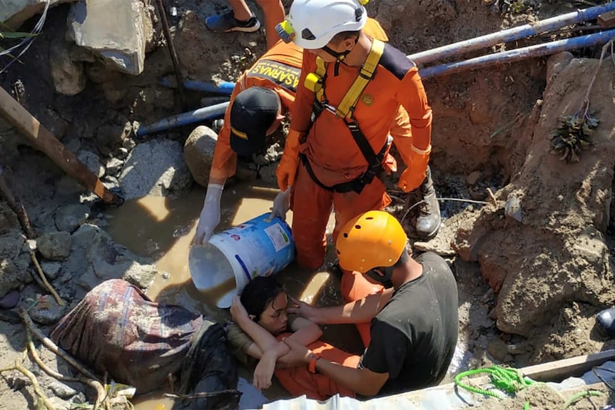 A person is rescued from rubble in Indonesia