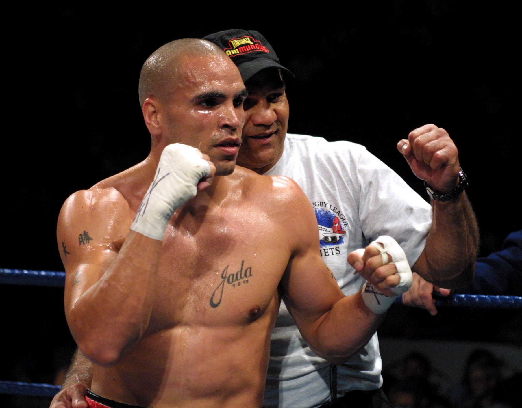 Australian Super Middleweight Boxer Anthony Mundine celebrates with his father Tony in the ring posing