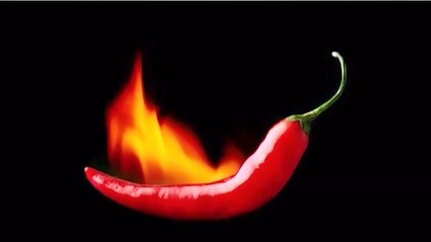 A red chilli with a flame behind it