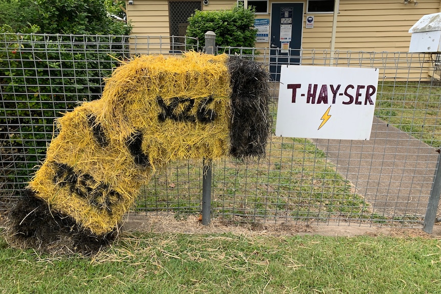 Haybale designed like a taser sits outside police station