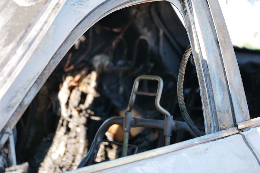 The interior of a burnt-out car.