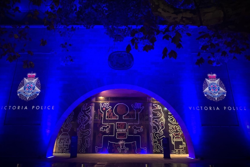 Blue light and the Victoria Police logo is projected onto the walls of the National Gallery of Victoria.