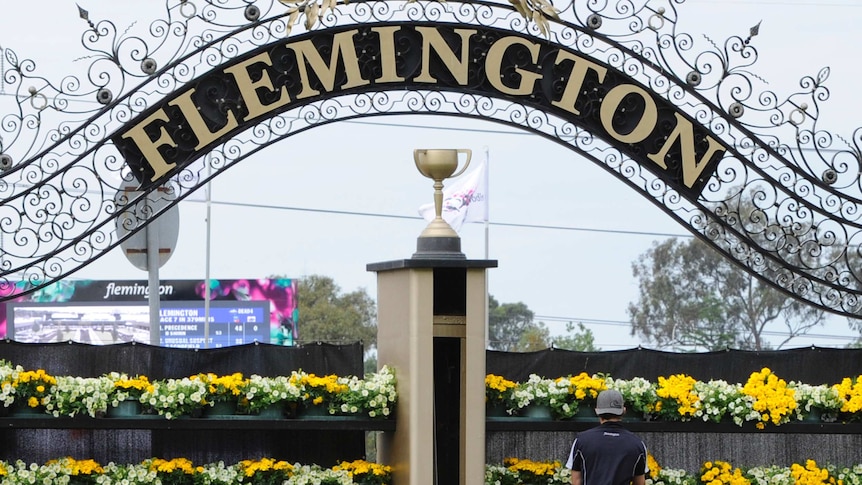 groundsman adds the finishes touches to the winning post at Flemington racecourse in Melbourne.