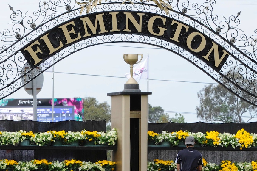 groundsman adds the finishes touches to the winning post at Flemington racecourse in Melbourne.