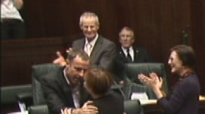 Greens leader Nick McKim and Premier Lara Giddings hug in the Tasmanian Parliament
