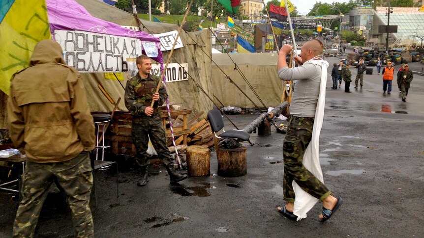 Activists play-fight with sticks in a square in Kiev, Ukraine.