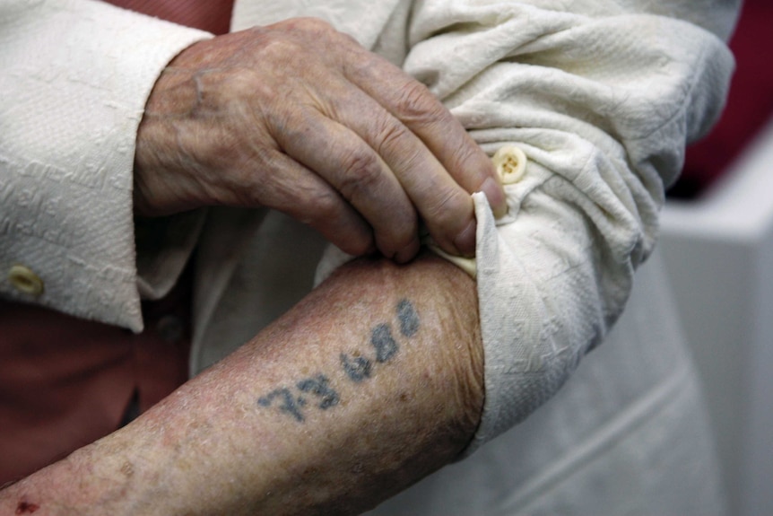 Holocaust survivor Meyer Hack shows his prisoner number tattooed on his arm during a news conference in 2009.