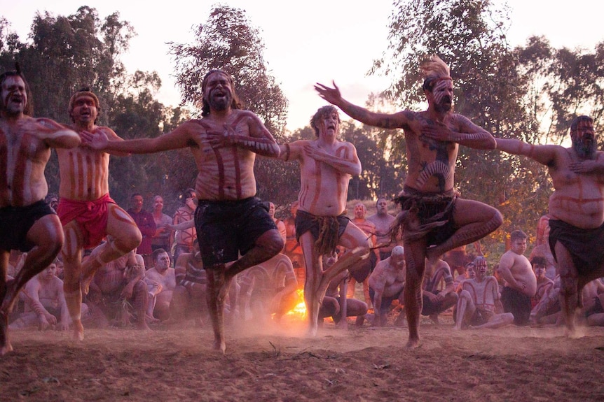 Aboriginal men dance in the twilight at the Wagga Wagga corroboree.