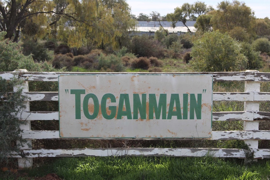 A sign on a gate reads Toganmain