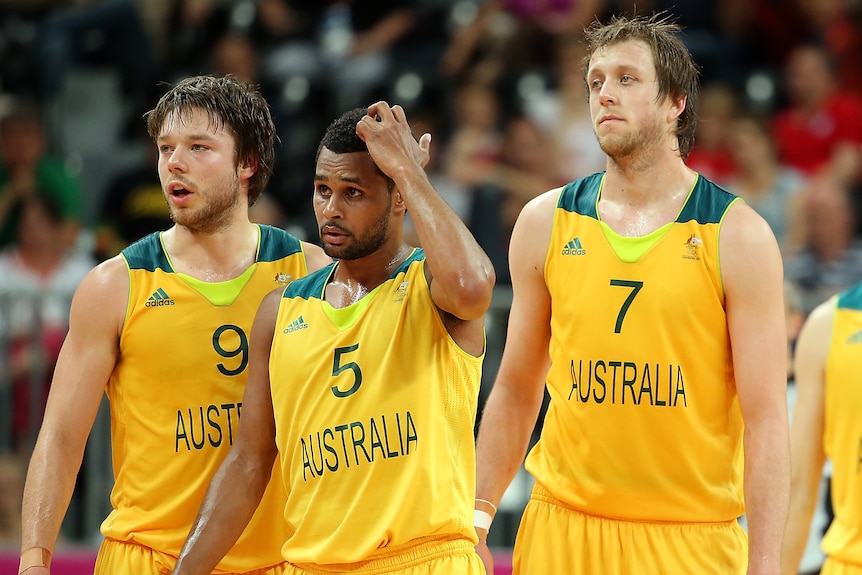 Matthew Dellavedova, Patty Mills and Joe Ingles walk on court during a basketball game at the London 2012 Olympic Games.