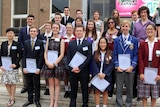20 students pose with their certificates.