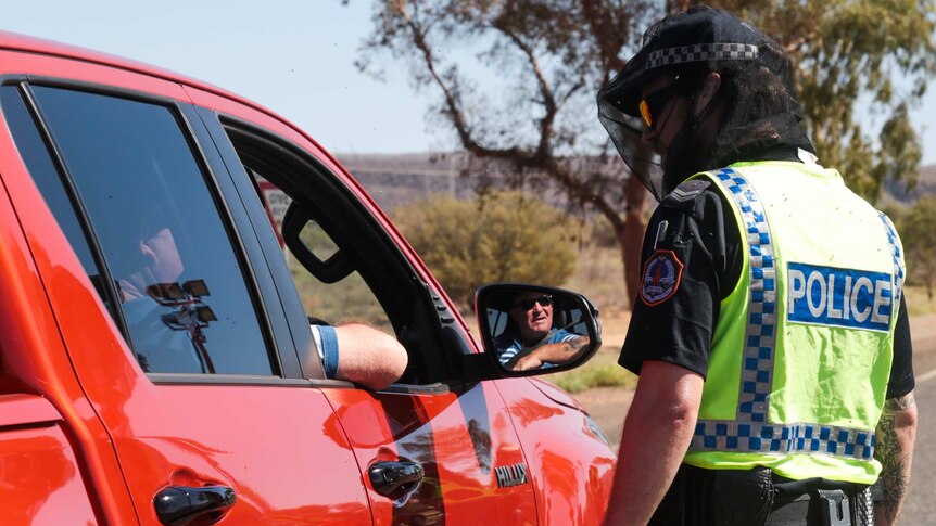 Police in Central Australia stop cars at a check point during the coronavirus pandemic, March 2020.