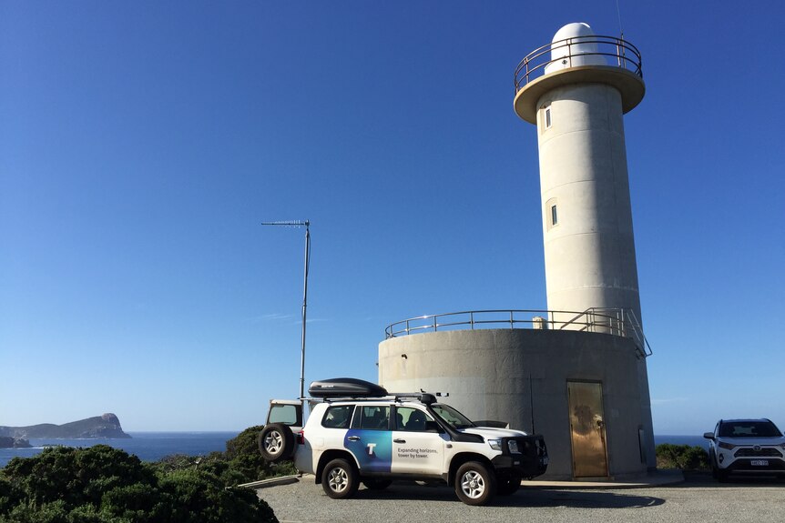Cave point lighthouse with a telstra car parked in front