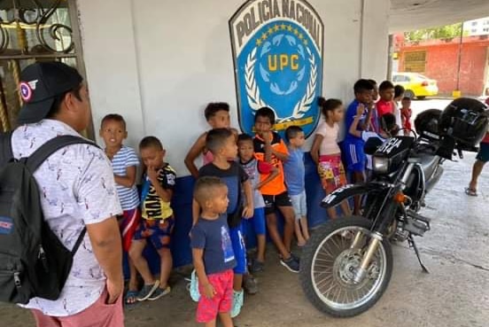 Young children stand outside the Chorrillo Community Preventative Unit building to take part in educational activities.