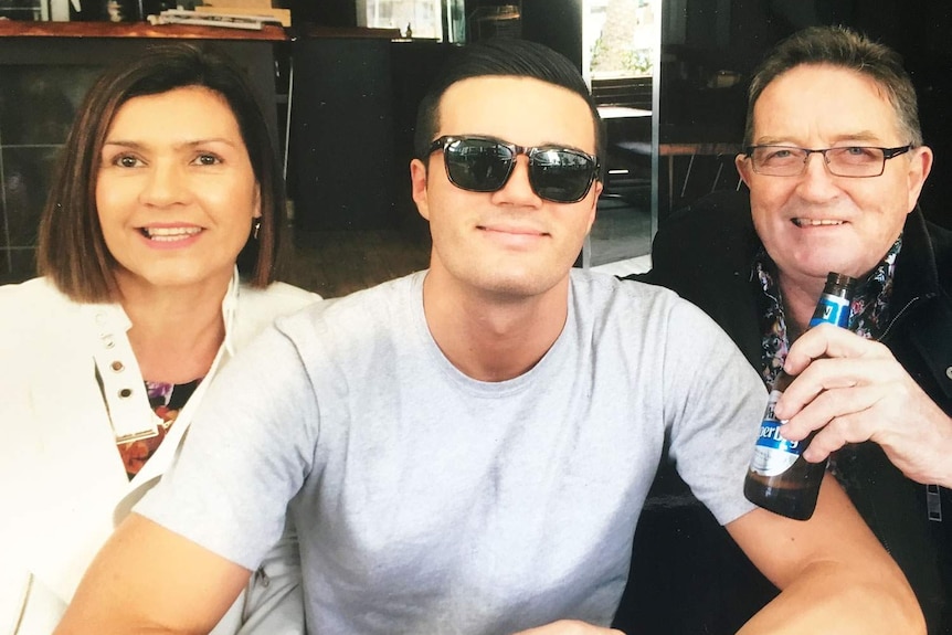 Charlie Robertson (centre) with his parents Graham and Rose, date unknown