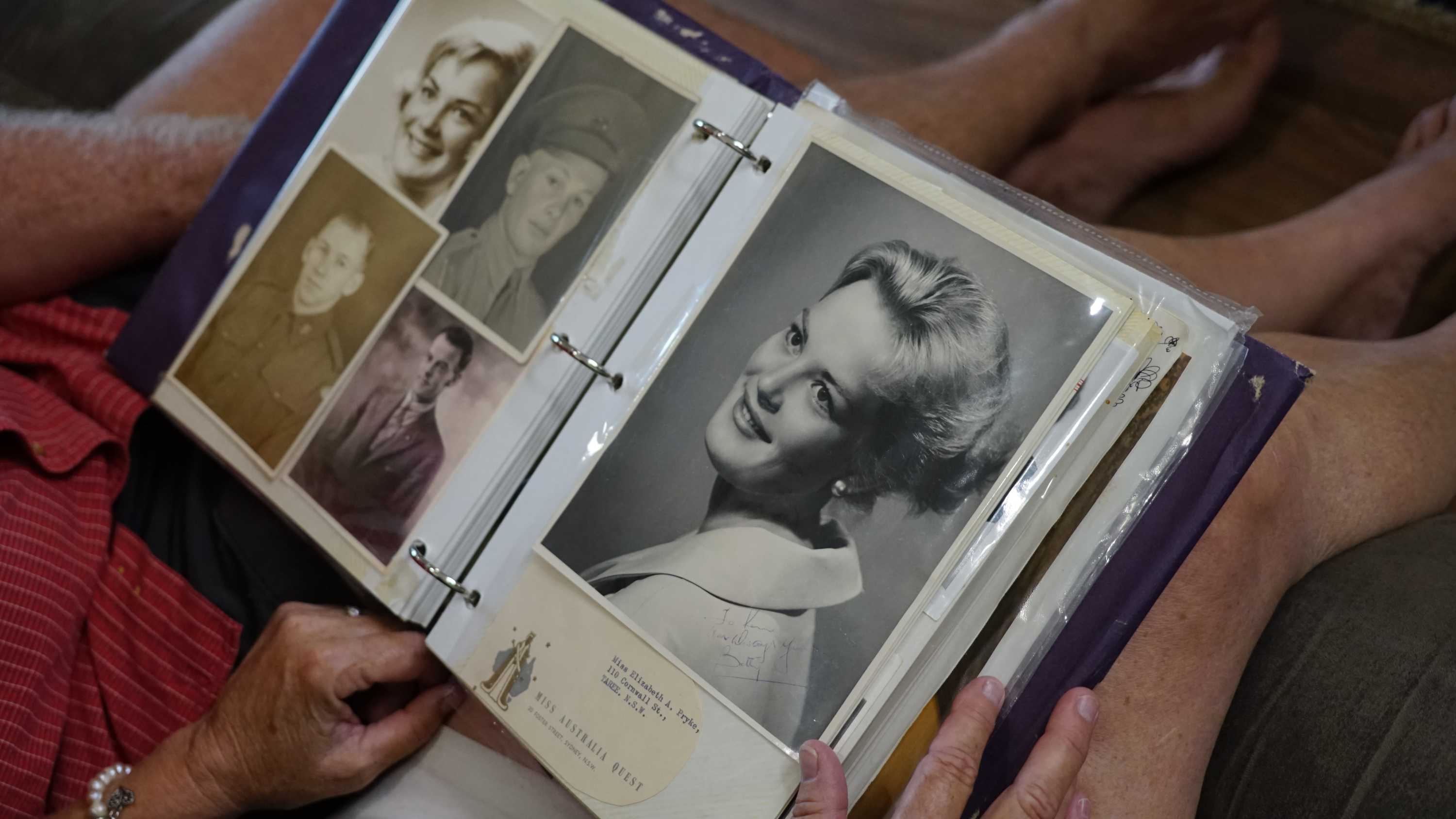 Black and white photos of Liz Holmes can be seen on the lap of her daughter Sharon.