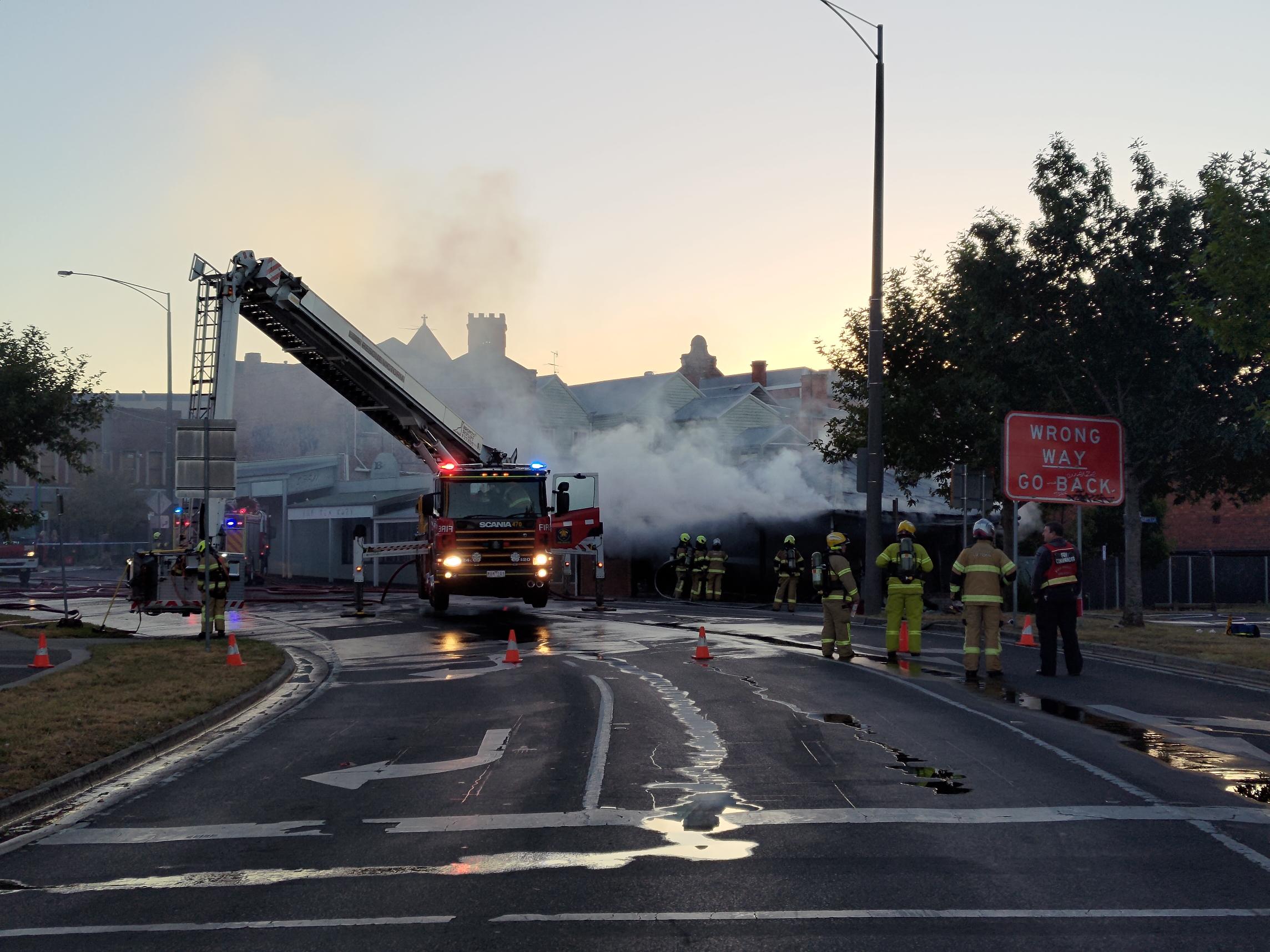 emergency services attempt to put out a large smokey fire