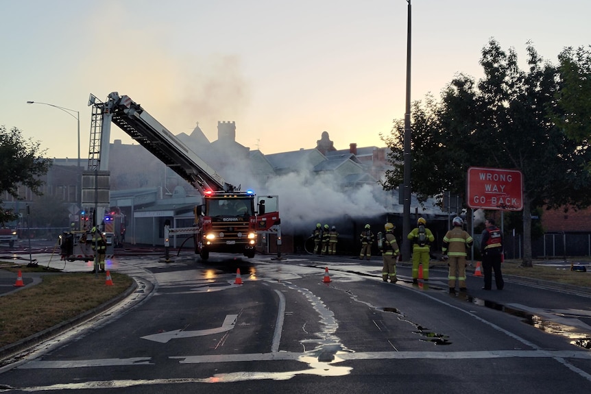 emergency services attempt to put out a large smokey fire