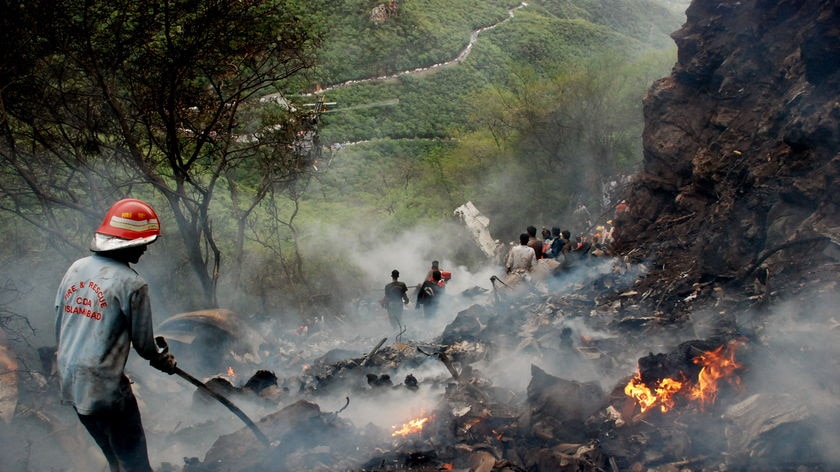 Rescue workers search for survivors among the wreckage.