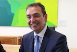 Steven Marshall smiling and seated.