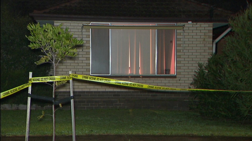 Crime scene tape in front of a house.