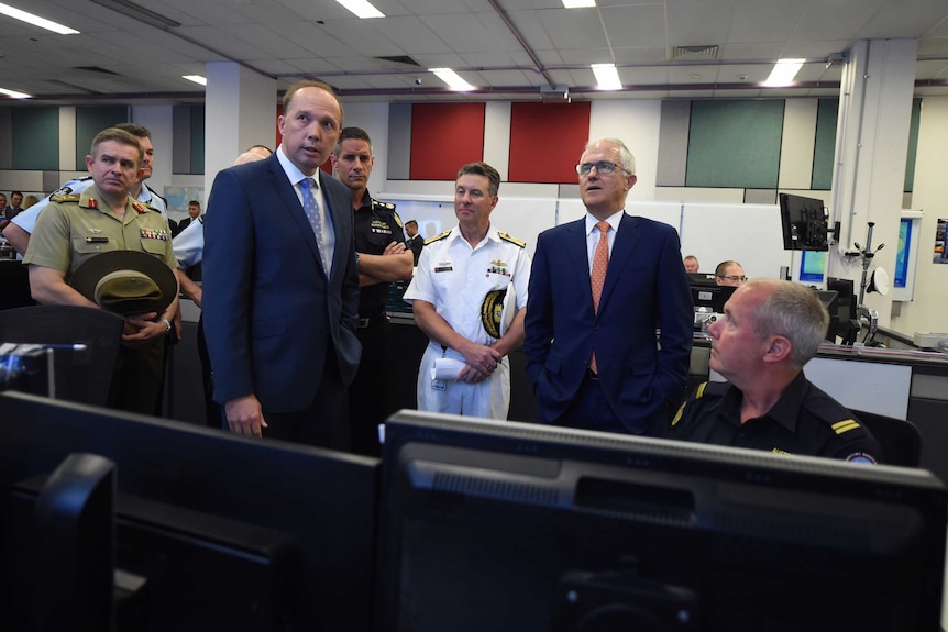 Prime Minister Turnbull and Peter Dutton on a tour of Australian Maritime Border Command Centre in Canberra.