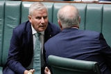 Michael McCormack leans in and speaks with Prime Minister Scott Morrison in the House of Representatives chamber