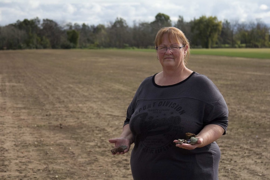 Carol Pohahau standing on farmland in Cornwallis beside the Rickaby River