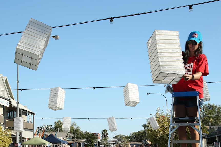 Haley Allan hangs lanterns for the annual Shinju Matsuri cultural festival.