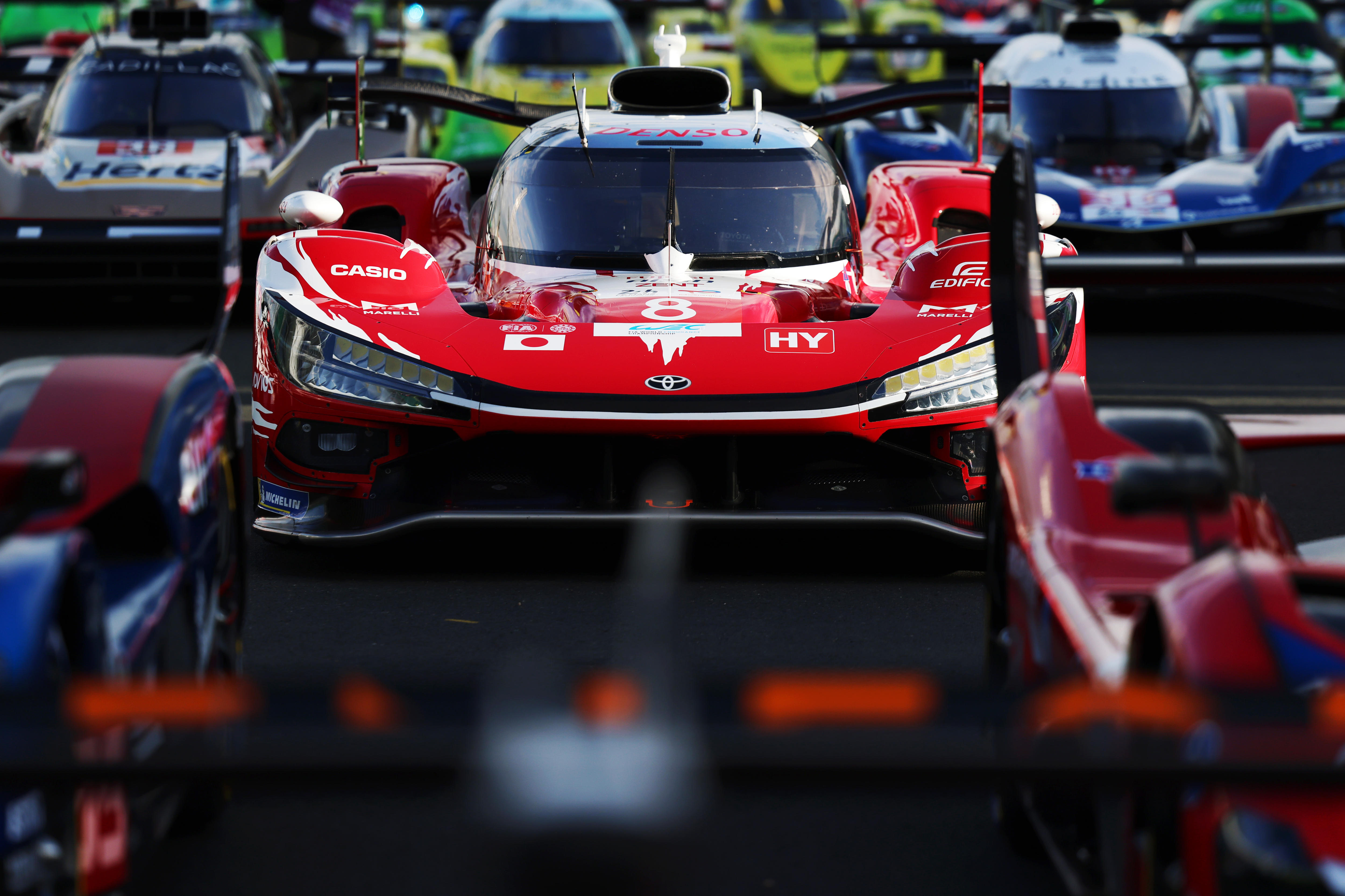 Endurance racing cars lined up on the grid for a promotional photograph