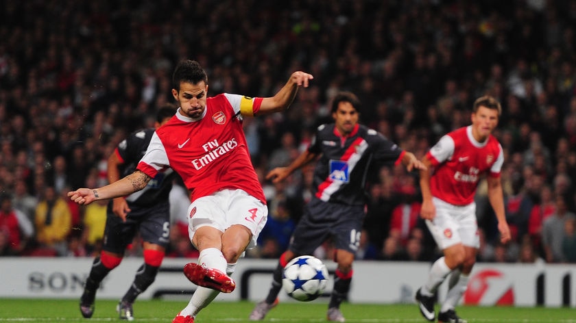 Arsenal captain Cesc Fabregas scores from the penalty spot during the 6-0 rout