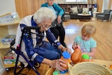Aged care residents play with young children