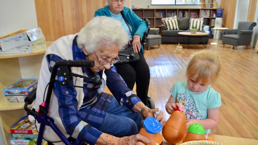 Aged care residents play with young children