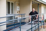 Mr Fairbairn on the wheelchair ramp outside his home.