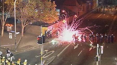 A firework is thrown at police during the riot in Redfern.