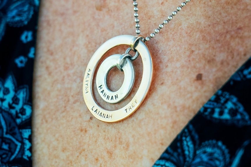 Sue Clarke wears Hannah's necklace engraved with the names of Hannah and her three grandchildren.