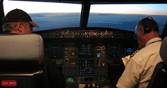 Two men sit in a cockpit