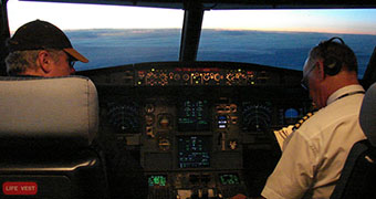 Two men sit in a cockpit
