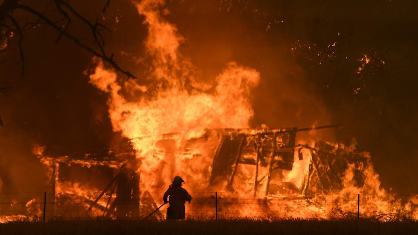 A firefighter surrounded by flames