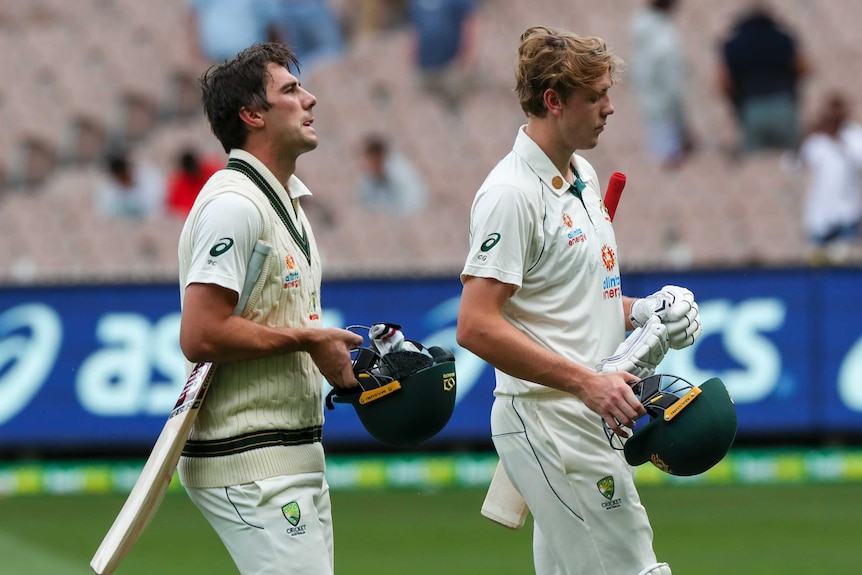 Australia batsmen Pat Cummins (left) and Cameron Green walk off the field on day three of the Boxing Day Test against India.